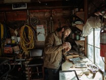 Tobias Corwin making jewels in his workshop.