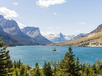 A large body of water surrounded by mountains - Glacier National Park