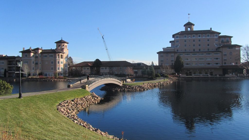 bridge over water in front of two buildings