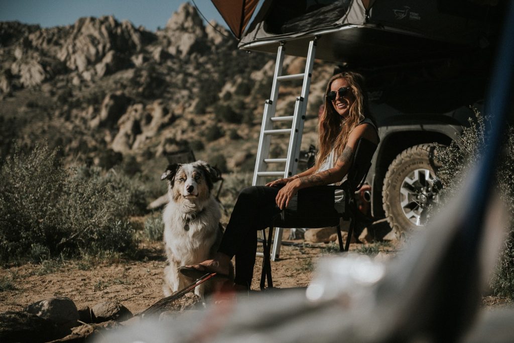 woman in K&Uuml;HL women's tank car camping with dog