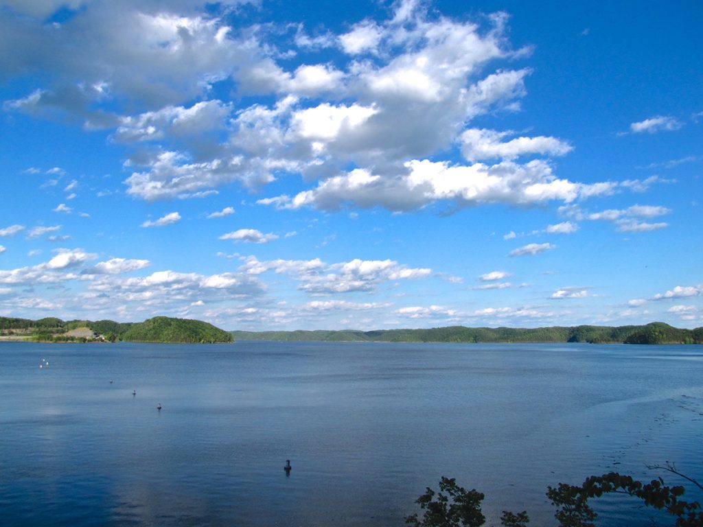 body of water under blue sky